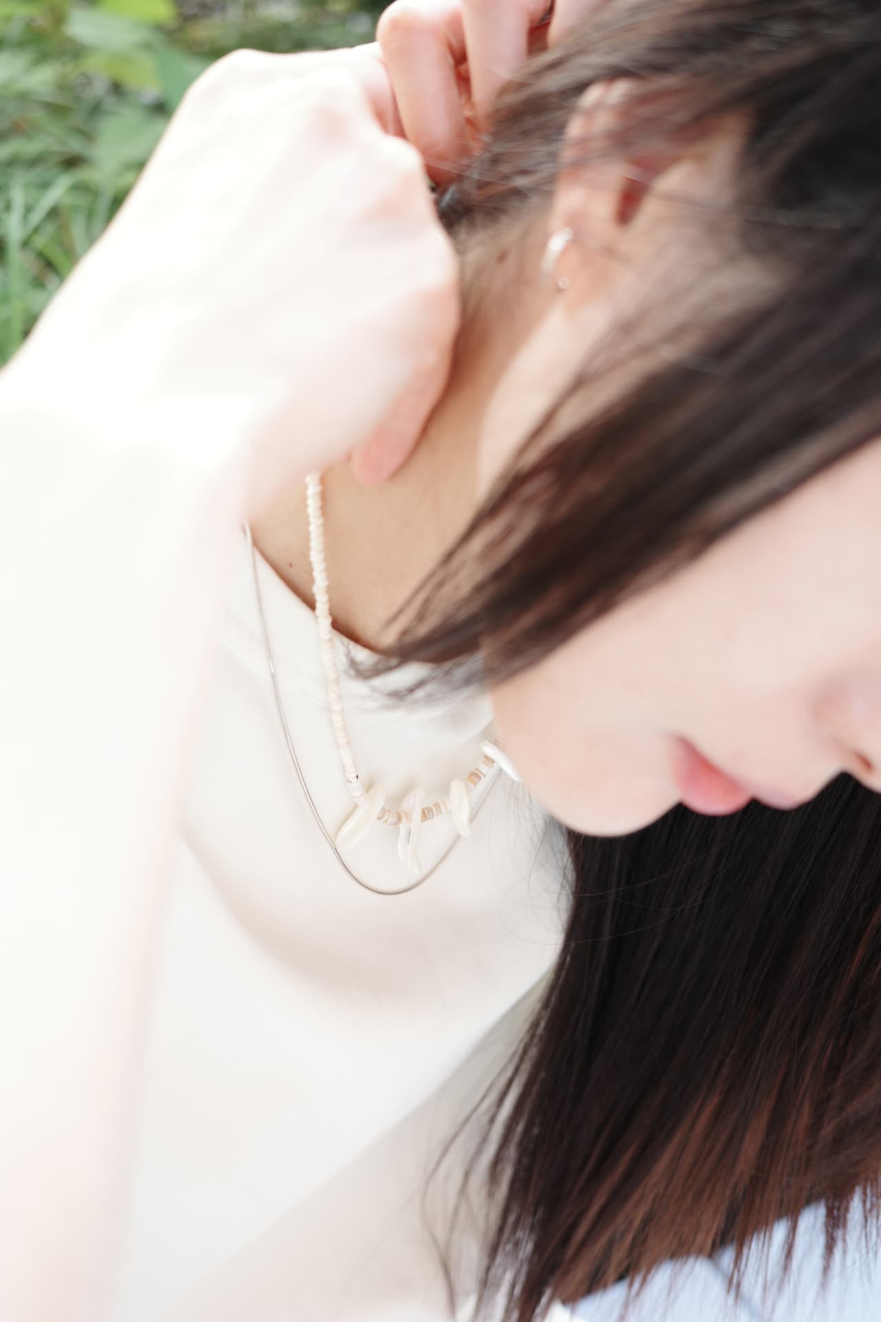 Shell and bead necklace, worn