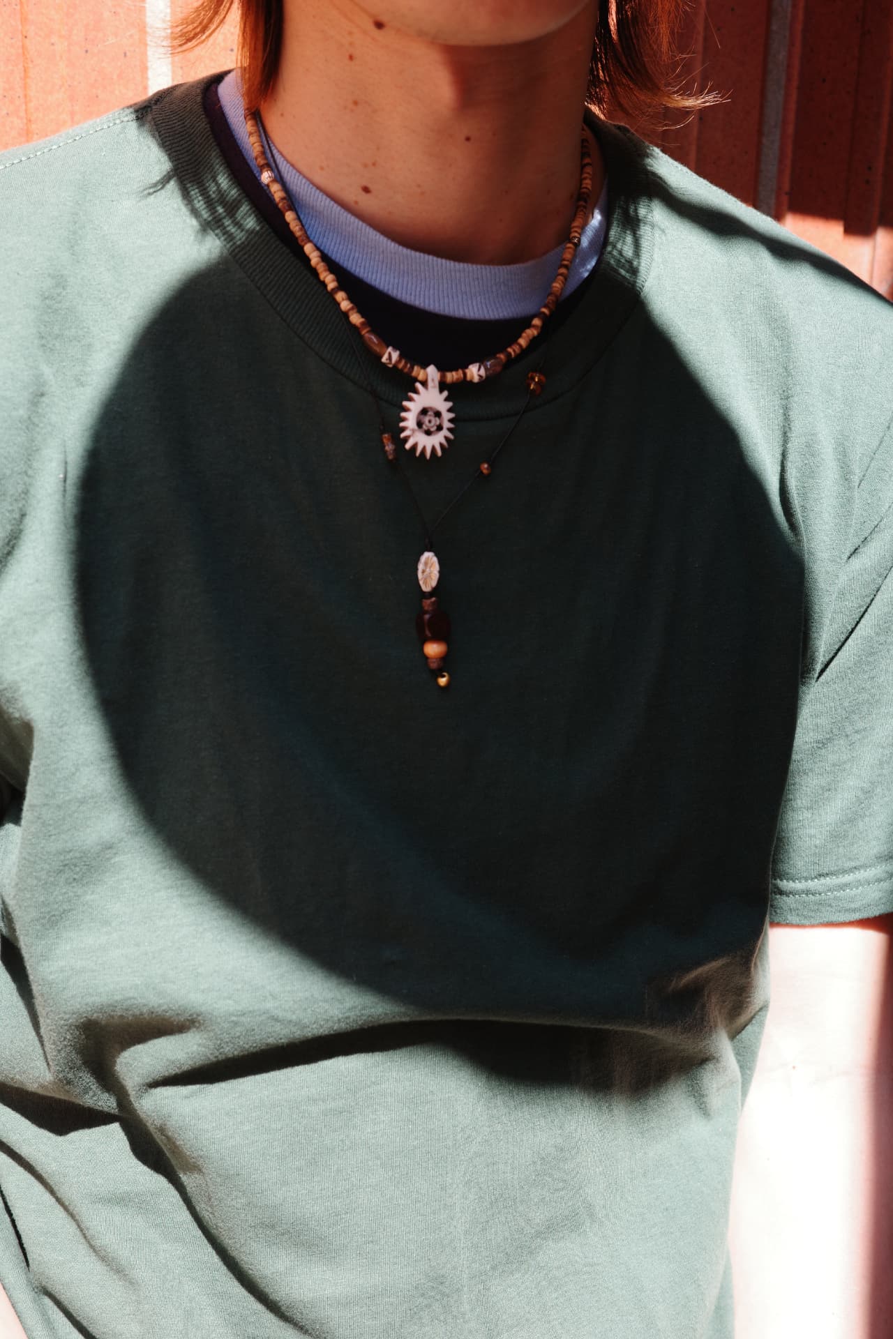 Layered necklaces, carved shell pendant